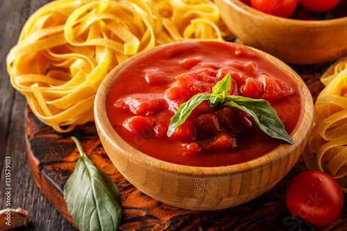 Products for cooking - tomato sauce, pasta, tomatoes, garlic.