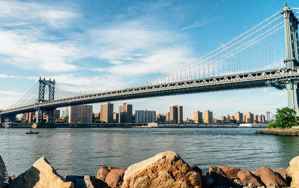 Naklejka premium Brooklyn Bridge in New York City at sunset. Vivid splittoned image.