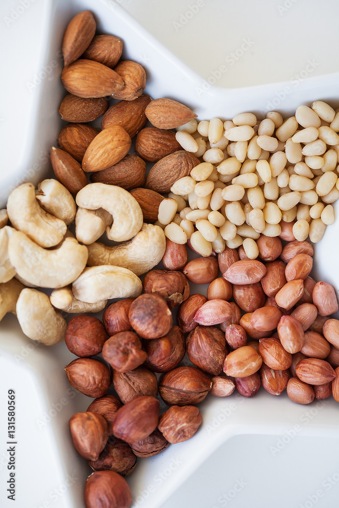 Mixed nuts in a dish in the form of stars, close-up Mixed nuts in a dish in the form of stars, close-up