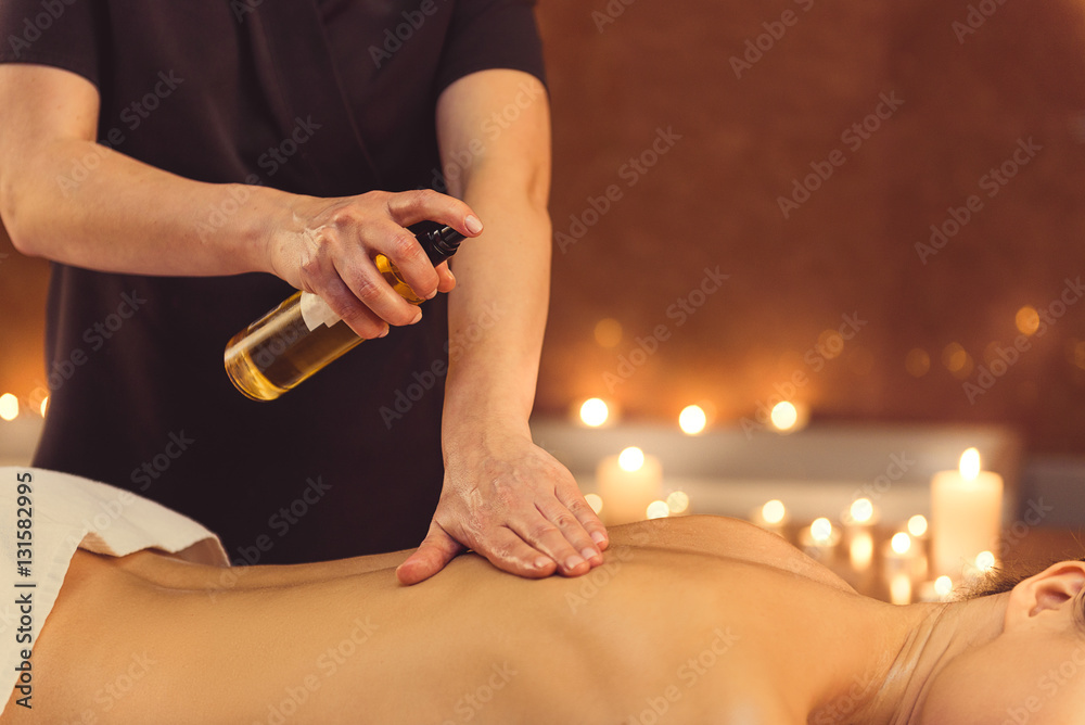 Skillful masseuse serving client at spa Skillful masseuse serving client at spa
