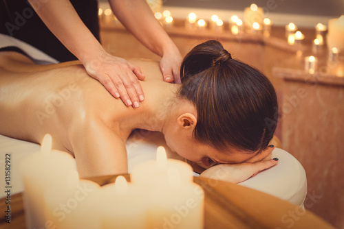 Relaxed girl getting massage at spa
