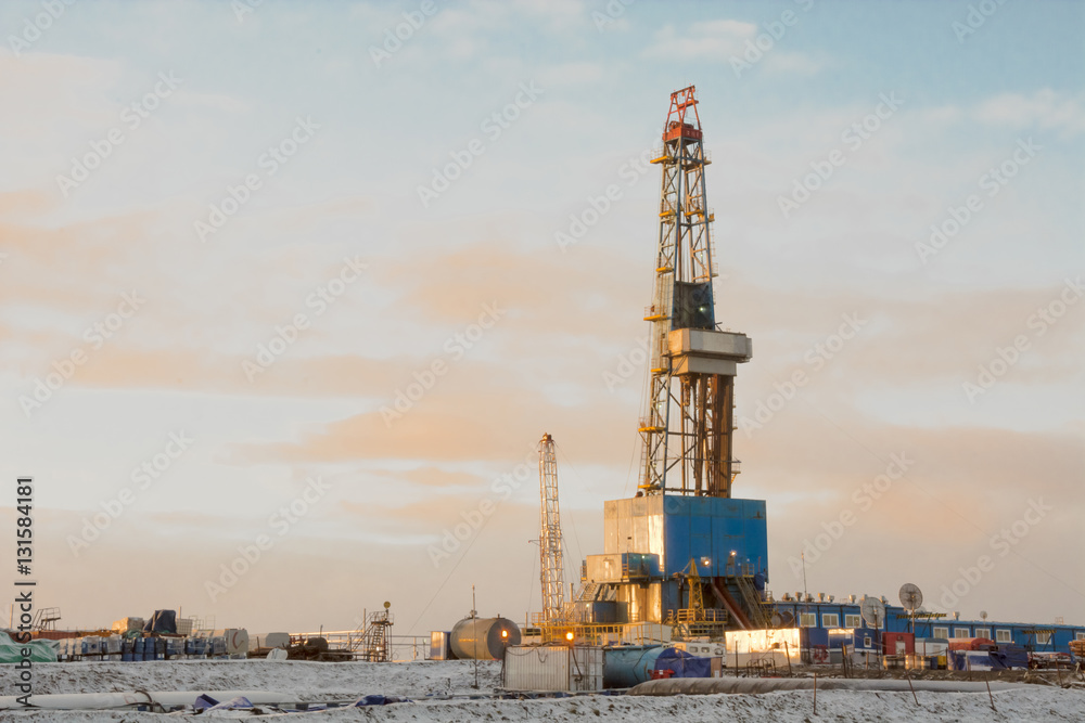 In the northern oil and gas field. Drilling rig. Before her lay the drill pipes.