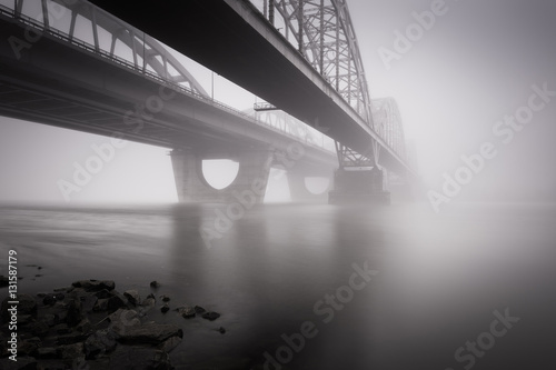 Two parallel bridges over foggy river. Long exposure shot.