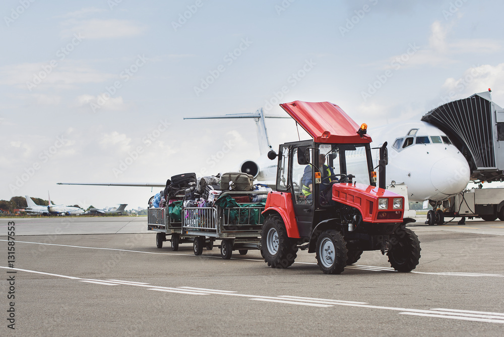 Fototapeta premium Vehicle with baggage near plane