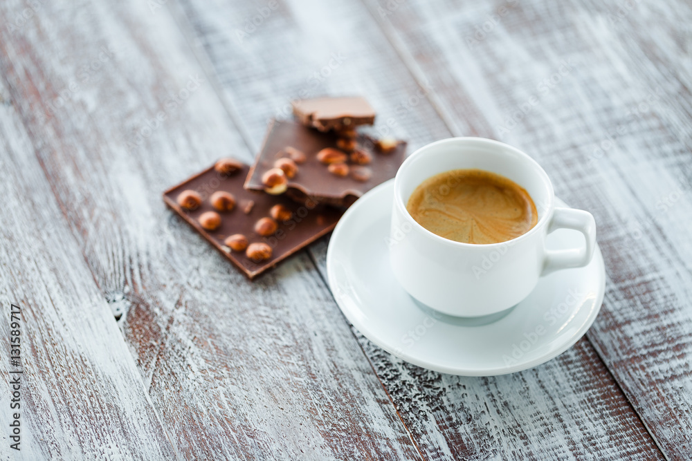 chocolate with coffee on a wooden white table chocolate with coffee on a wooden white table