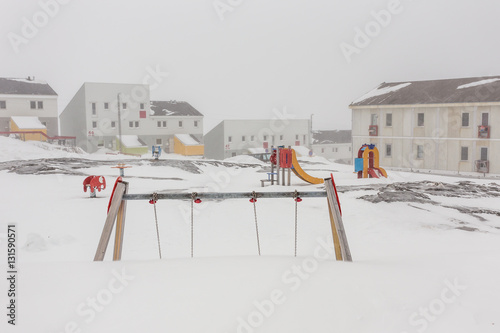 Harsh greenlandic childhood,playground covered in snow and ice i