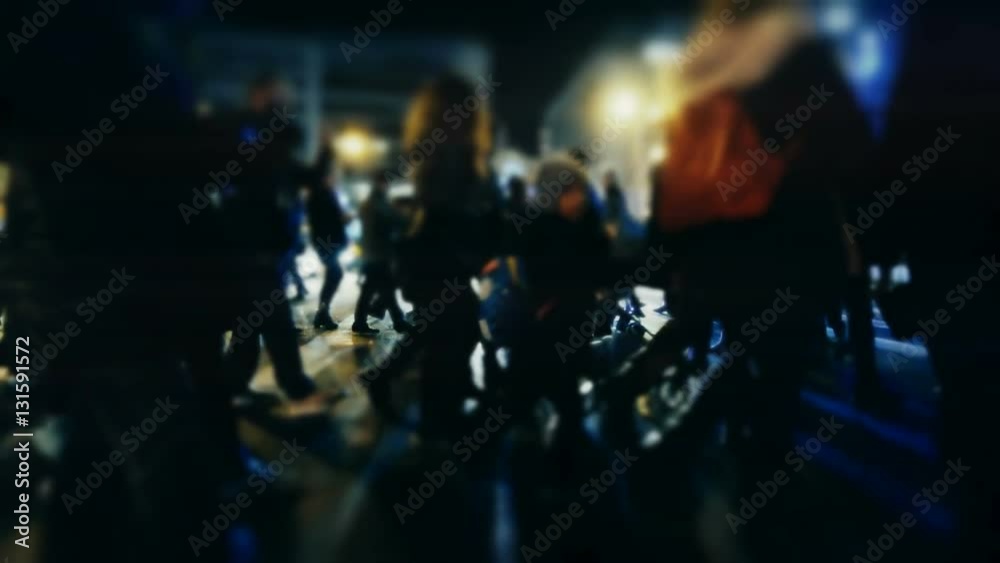 City pedestrians on winter night, cross street, slowmo 100p.Stabilized dolly shot of an anonymous crowd of pedestrians crossing a busy intersection at night.No logos/faces visible.Commercial shot. City pedestrians on winter night, cross street, slowmo 100p.Stabilized dolly shot of an anonymous crowd of pedestrians crossing a busy intersection at night.No logos/faces visible.Commercial shot.