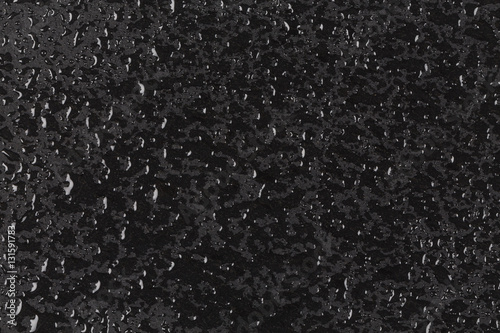 Water drops on dark stone surface