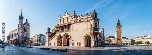 Panorama of Main Market Square (Rynek) in Cracow, Poland with the Renaissance Drapers' Hall (Sukiennice), Gothic St Mary church, medieval city hall tower. The biggest medieval market square in Europe photo