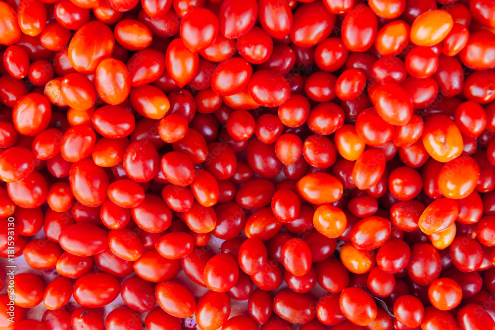 Close-up of a bunch of red cherry tomatoes in a greengrocer's sh Close-up of a bunch of red cherry tomatoes in a greengrocer's sh
