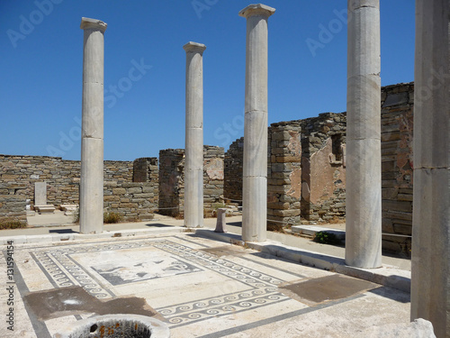 Ruins of an ancient Greek temple with mosaic on a floor and white columns, Delos, Greece