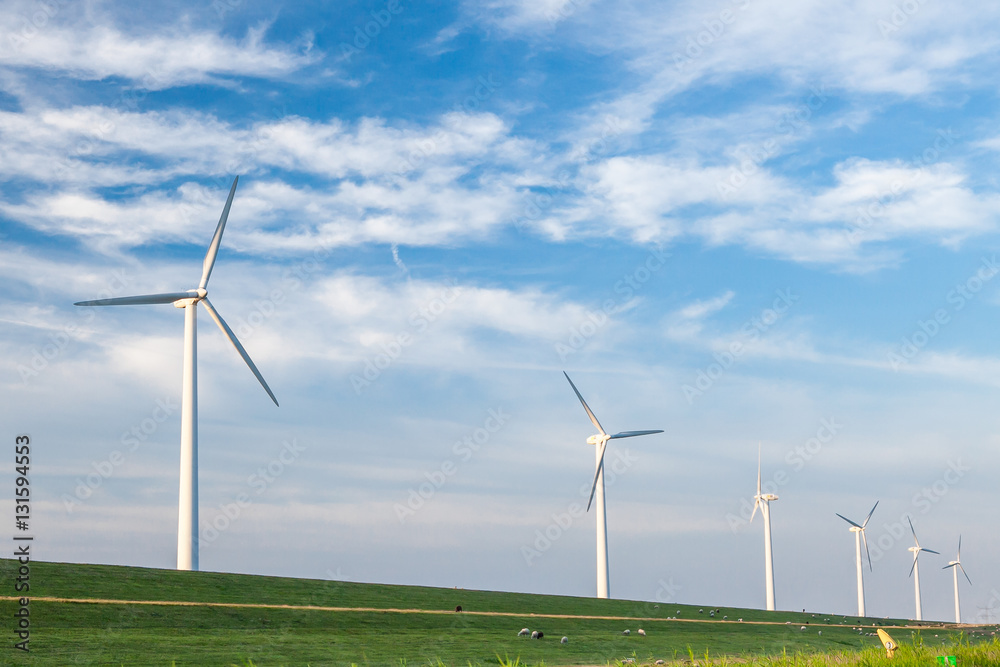 The wind powers in the field against the sky The wind powers in the field against the sky