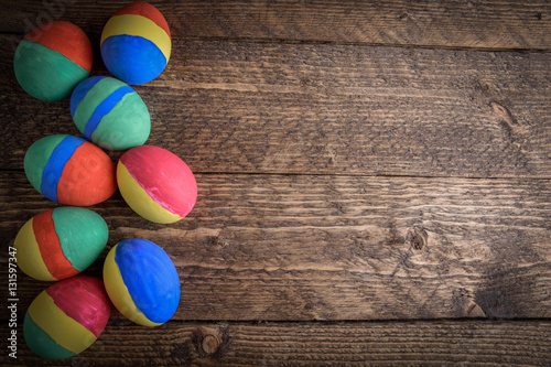 painted Easter eggs on wooden background