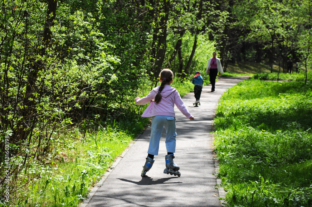 Little girl on roller skates in the park Little girl on roller skates in the park