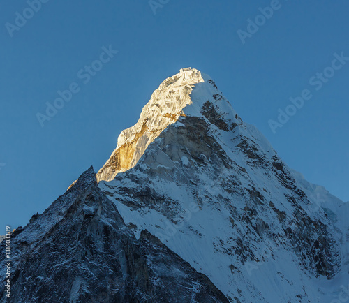 The first rays of the morning sun on the Ama Dablam (6814 m), view from the Chhukhung Ri - Everest region, Nepal photo