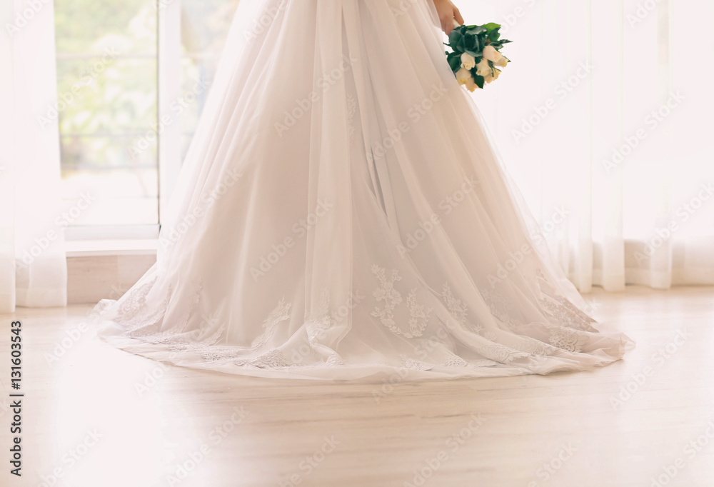 Bride in beautiful dress holding wedding bouquet Bride in beautiful dress holding wedding bouquet