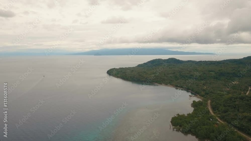 Aerial view coastline on tropical island with sea,road, trees and palms. Aerial footage.Aerial video from flying drone of amazingly beautiful landscape of nature with mountains,hills, rain forest Aerial view coastline on tropical island with sea,road, trees and palms. Aerial footage.Aerial video from flying drone of amazingly beautiful landscape of nature with mountains,hills, rain forest