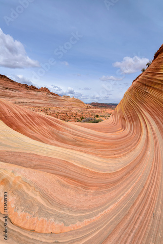 A big, colorful and swirling sandstone rock formation at the entrance way of The Wave - a dramatic erosional sandstone rock formation located in North Coyote Buttes area at Arizona-Utah border. 
