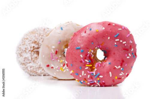 Three donuts isolated on White Background. Pink, Frosted and Coconut with sprinkles.
