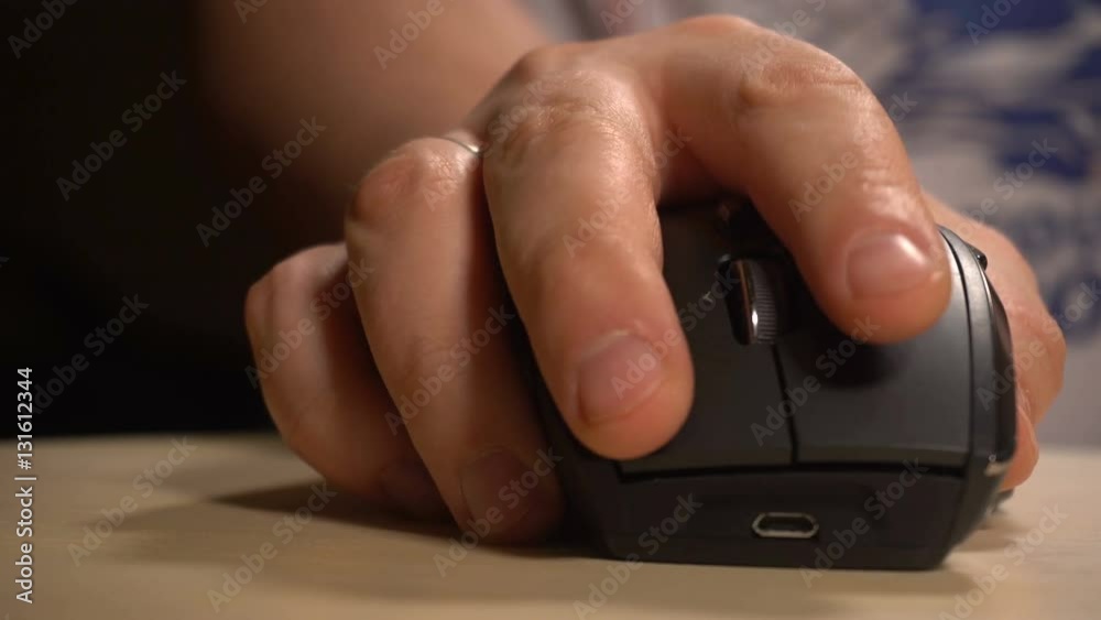 Hand of man clicking and scrolling mouse Hand of man clicking and scrolling mouse
