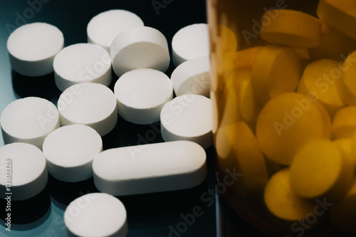 Pills next to pill bottles