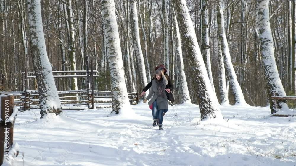 loving happy young couple emotionally runs in the winter woods. loving happy young couple emotionally runs in the winter woods.