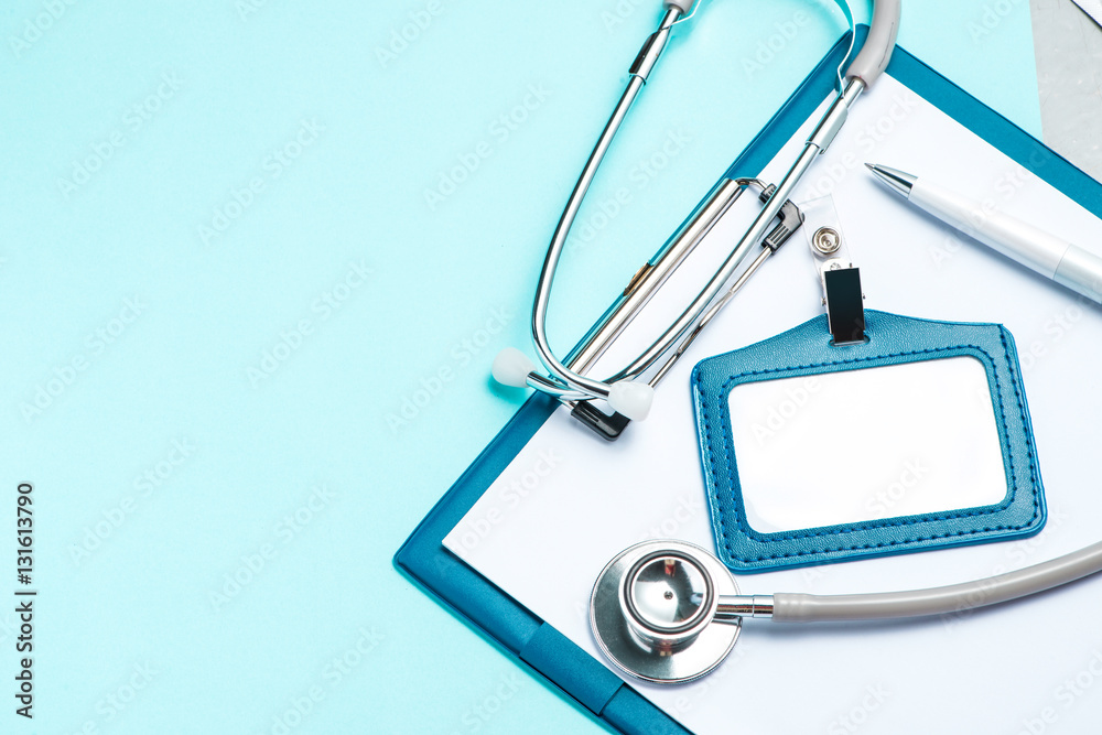 Stethoscope and medical equipment and blank clipboard on a light blue background. Stethoscope and medical equipment and blank clipboard on a light blue background.