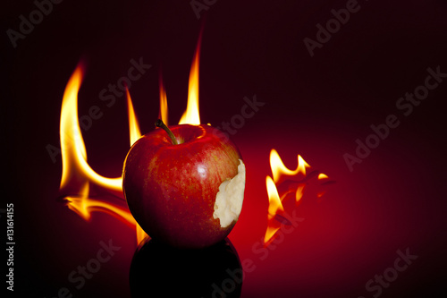 One sinful bite from apple with flames