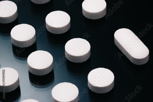 Organized Pills with an odd shaped on Reflective Surface