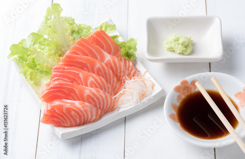 salmon sashimi on white dish with Shoyu Sauce and wasabi