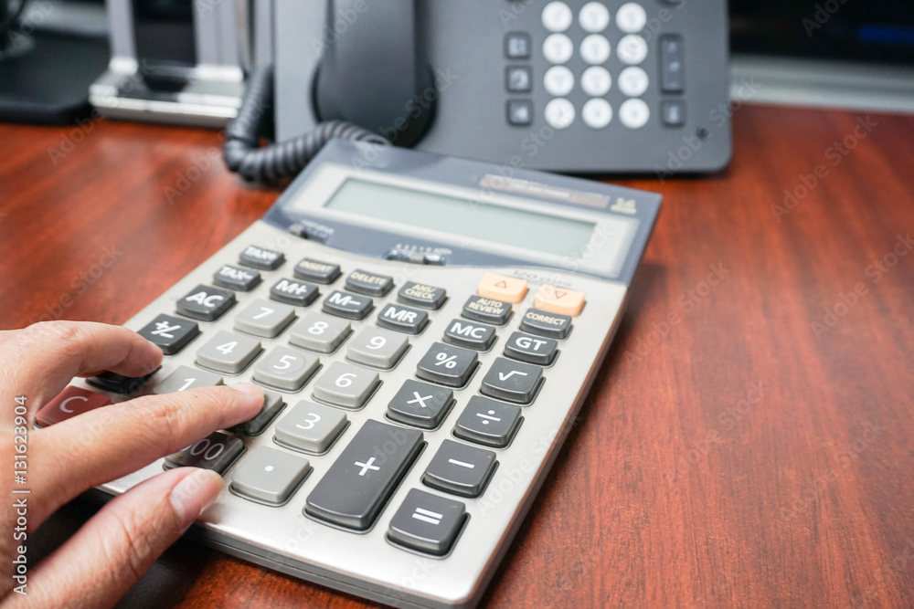 woman use calculator in office for tax and income calculation woman use calculator in office for tax and income calculation