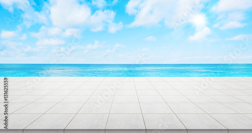 Business concept - Empty concrete floor top with panoramic ocean view under sunrise and morning blue bright sky for display or montage product