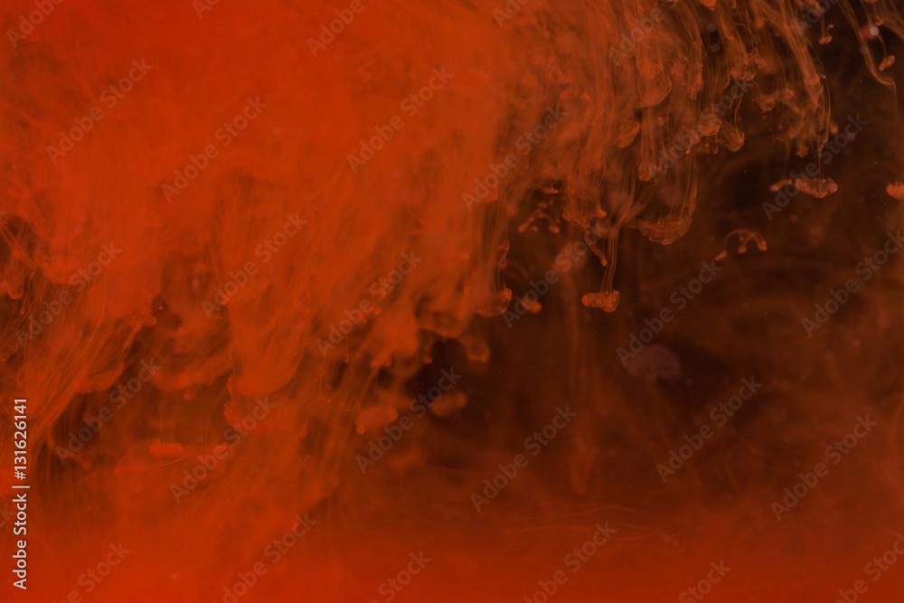 Red paint on the dark background doing stains because of drop into water. Looks like blood. Red paint on the dark background doing stains because of drop into water. Looks like blood.
