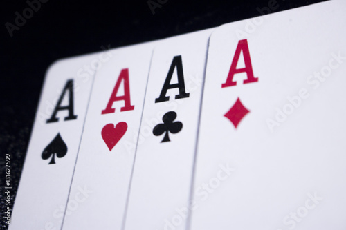 ace four of a kind poker card on dark black background