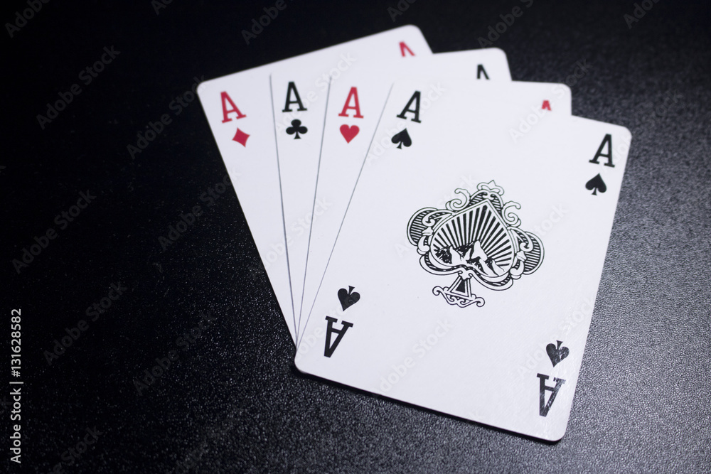 Obraz premium ace four of a kind poker card on dark black background