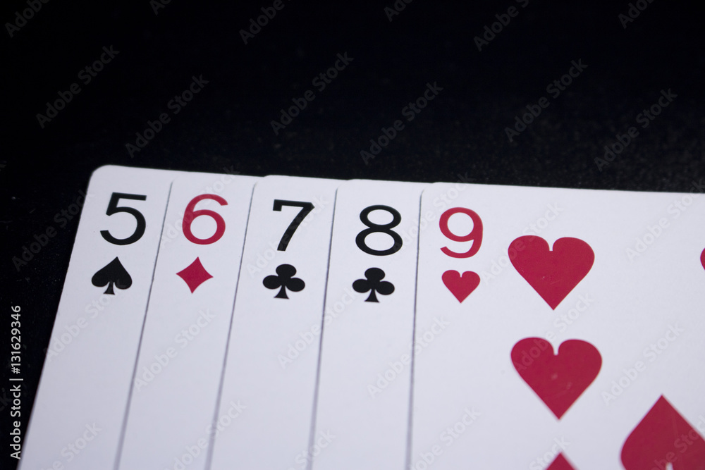 Fototapeta premium straight poker card on dark black background