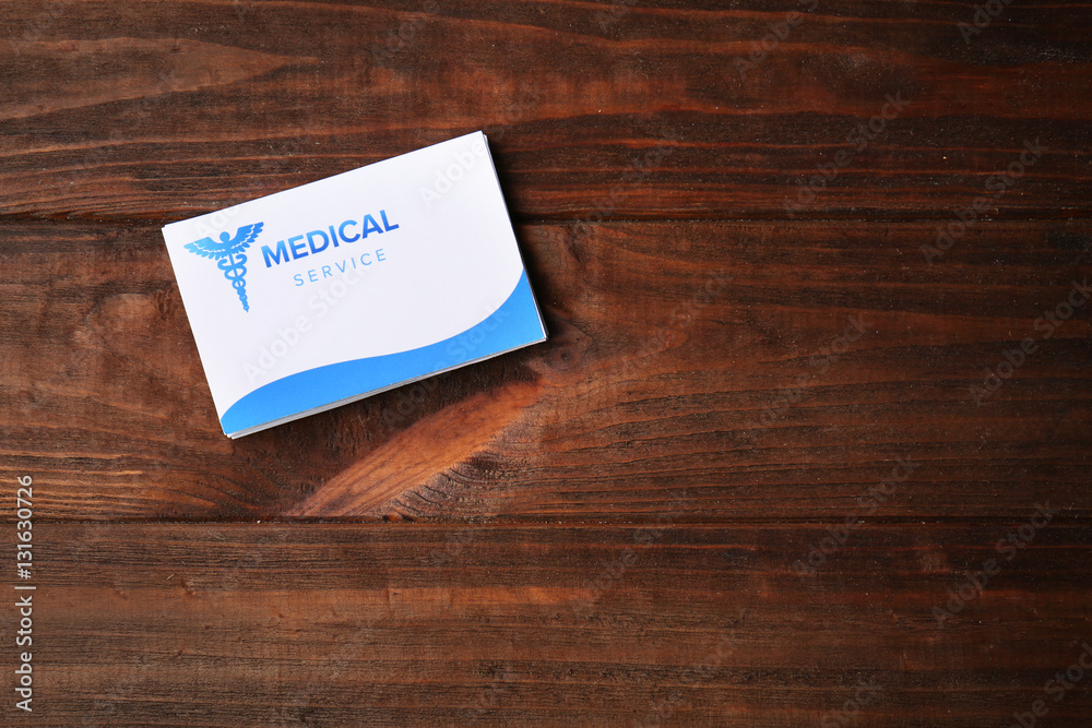 Card on wooden background. Medical service concept Card on wooden background. Medical service concept