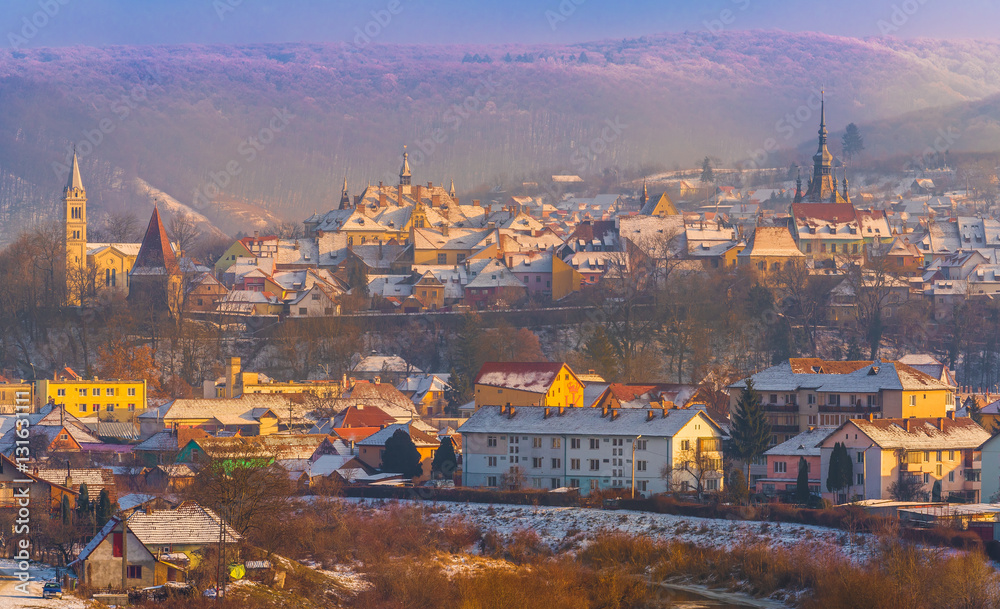 Panoramic view over the medieval fortress Sighisoara city in winter season, Transylvania, Romania