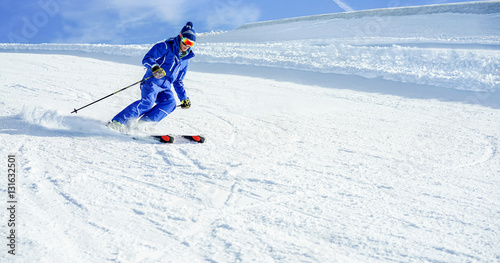 Young athlete skiing in Deux Alps french mountains on sunny day