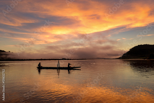 The silluate fisherman boat in river  on during sunrise,Thailand © saravut