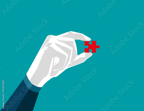 Businessman hand holding puzzle, red puzzle isolated on white