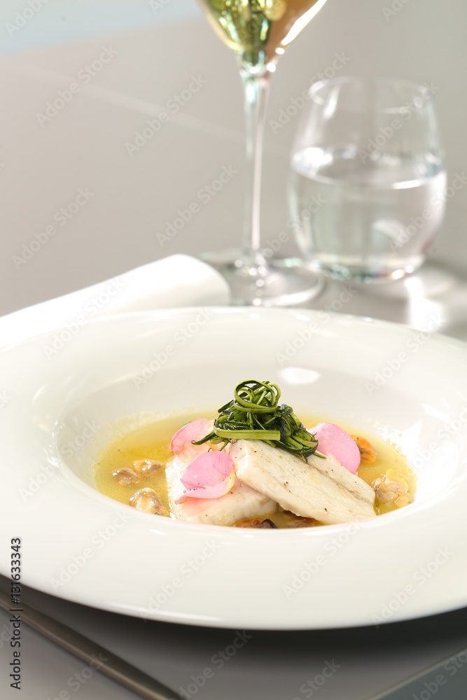 Fine dining - fish dish with pink rose petals Fine dining - fish dish with pink rose petals