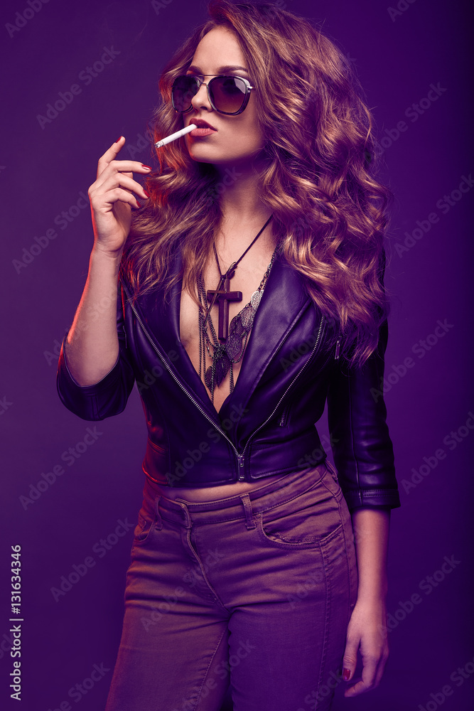 Portrait of elegant blonde woman in glasses smoking a cigarette Portrait of elegant blonde woman in glasses smoking a cigarette