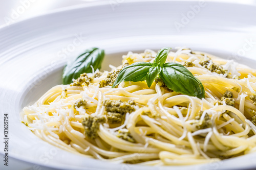 Spaghetti. Spaghetti with homemade pesto sauce olive oil and basil leaves.