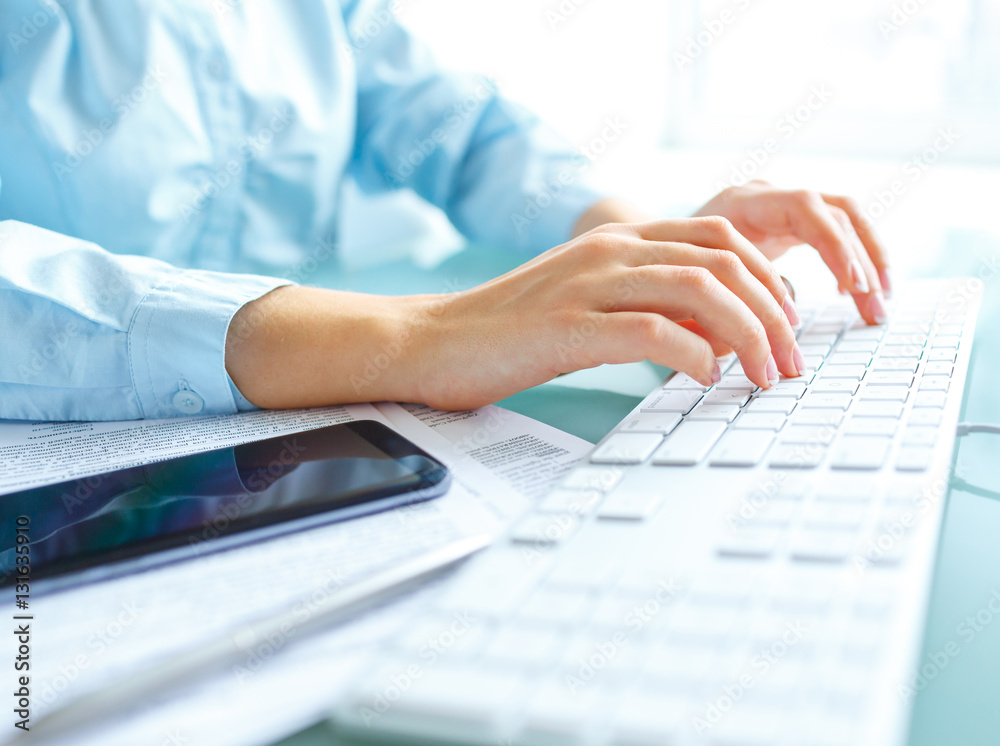 Woman office worker typing on the keyboard Woman office worker typing on the keyboard