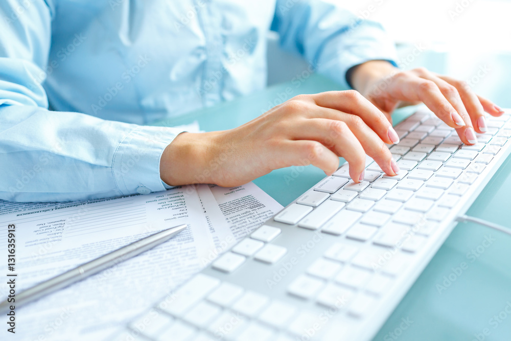 Woman office worker typing on the keyboard Woman office worker typing on the keyboard