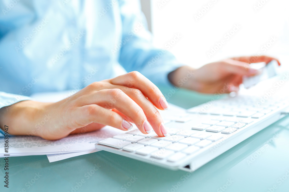 Hands using computer and credit card Hands using computer and credit card
