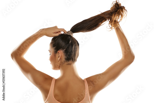 young woman tied her hair in a ponytail
