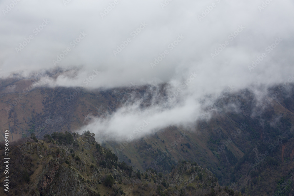 The formation and movement of spring clouds over the high Caucasus mountains