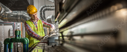 Portrait of a worker, constructing and checking development of a small business hall. Reliable civil engineer working on a construction site, foreman at work